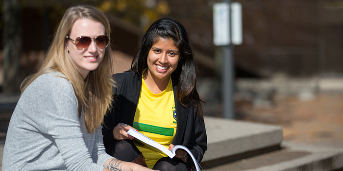 Picture of two Centennial College students outside Ashtonbee Campus in the summer